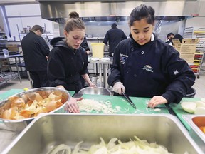 The Unemployed Help Centre has been awarded a grant to start a Farm to Food program. The project will allow the centre to make healthy fresh soup for thousands of needy people at area food banks. Tianna Monroe, 17, left, and May Zitzelberger, 18, students from Herman Secondary School work in the centre's kitchen on Monday, December 10, 2018.