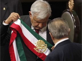 Mexico's new President Andres Manuel Lopez Obrador holds the presidential sash after taking the oath of office at the National Congress in Mexico City on Dec. 1, 2018.