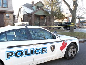 A Windsor police vehicle sits by a home at 1715 Windermere Rd. on Dec. 30, 2018.