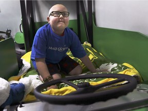 Huntre Allard, 9, react to seeing his new redesigned bedroom on Tuesday, December 11, 2018 at his Windsor home. The Make-a-Wish Foundation granted Huntre's wish for a John Deere-themed bedroom.