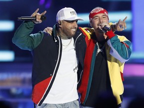 FILE - In this April 26, 2018 file photo, Nicky Jam, left, and J Balvin perform "X (Equis)" at the Billboard Latin Music Awards in Las Vegas. The song is named as one of the top songs of the year by Associated Press Music Editor Mesfin Fekadu.