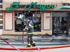 Firefighters work at a fire scene at El-Mayor Restaurant and other businesses on Wyandotte Street East between Parent Avenue and Langlois Avenue. Heavy damage at the El-Mayor building which was once the White Laundry Comp. building dating back to the 1920s.
