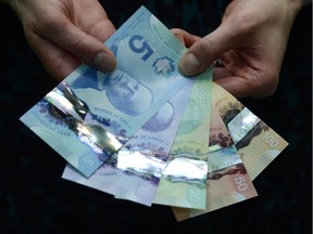 Polymer bank notes are shown during a news conference at the Bank of Canada in Ottawa on April 30, 2013.