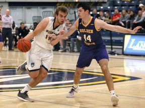 University of Windsor Lancers Anthony Zrvnar, left, drives against Laurier Golden Hawks Ben Stevens in OUA men's basketball action from St. Denis Centre on Saturday.