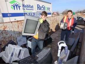 Jonathan Roehler of Habitat for Humanity Windsor-Essex, and volunteer Mark Rawlings, right, and other volunteers had no problem filling  disposal bins with electronics and appliances during Habitat for Humanity's Eco-Heros event Saturday at Home Depot (South).