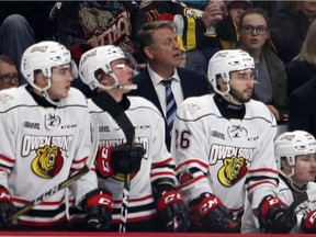 Former Windsor Spitfires defenceman Todd Gill, centre, on the bench for the Owen Sound Attack. Gill was relieved of his duties as head coach of the team on Monday.