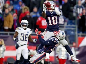 Matthew Slater #18 of the New England Patriots intercepts a pass during the fourth quarter in the AFC Divisional Playoff Game against the Los Angeles Chargers at Gillette Stadium on January 13, 2019 in Foxborough, Massachusetts.