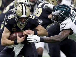 Drew Brees #9 of the New Orleans Saints is tackled by Malcolm Jenkins #27 of the Philadelphia Eagles during the first quarter in the NFC Divisional Playoff Game at Mercedes Benz Superdome on January 13, 2019 in New Orleans, Louisiana.