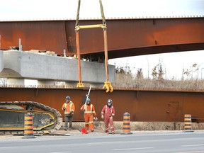 In this Jan. 16, 2019, photo, workers are shown on the site of a bridge being built over Ojibway Parkway and connecting the Herb Gray Parkway to the new Gordie Howe Bridge. A dispute erupted this week between two labour unions over who does some of the overpass work.