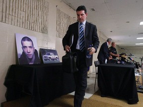 Windsor Police Staff Sgt. William Donnelly exits past a picture of Jesse Imeson following  a press conference in the town of Exeter, Ont. on July 24, 2007.