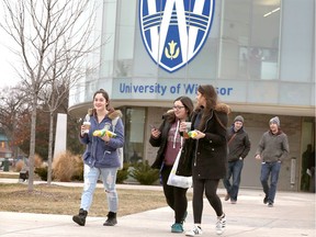 University of Windsor students Mackenzie Jordan, left, Amelia Dimitroff and Deanna Kadri walk outside the Stephen and Vicki Adam Welcome Centre at the main campus of the University of Windsor on Jan. 17, 2019.