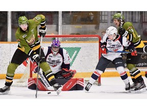 North Bay's Justin Brazeau tries to tip a puck in front of goalie Colton Incze while Windsor defenceman Nathan Staios tries to keep Battalion forward Matthew Struthers away from the net on Thursday.
Photo courtesy: Sean Ryan