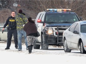 Following a traffic stop on Scott Side Road, an OPP officer holds his taser in his right hand as a man approaches Tuesday January 29, 2019. The officer pulled over a damaged Chrysler sedan and called for backup.  Four other OPP units arrived within minutes. The man, and a woman with a baby were taken away in separate police vehicles.