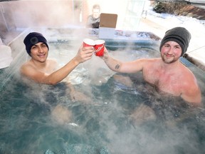University of Windsor students Mihir Dalwadi, left, and Cameron Breshamer toast to their success during a Sigma Chi fraternity hot-tub-a-thon fundraiser for The Huntsman Cancer Institute. The Huntsman Institute is a research facility and hospital seeking treatments to improve quality of life for cancer patients, survivors and their family.  The hot-tub-a-thon is located outside CAW Student Centre and will continue through Friday.
