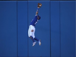 Kevin Pillar of the Toronto Blue Jays makes a leaping catch as he slams into the wall in the fifth inning during MLB game action against the Detroit Tigers at Rogers Centre on Sept. 9, 2017 in Toronto.