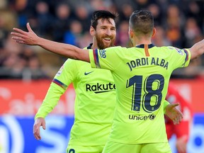 TOPSHOT - Barcelona's Argentinian forward Lionel Messi (L) celebrates with Barcelona's Spanish defender Jordi Alba after scoring a goal during the Spanish league football match between Girona FC and FC Barcelona at the Montilivi stadium in Girona on January 27, 2019.