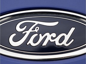 FILE  - In this Tuesday, Aug. 22, 2017 file photo, a Ford emblem is seen on a car at a store in London. Ford Motor Co. says it is cutting jobs in Europe in a wide-ranging restructuring as it focuses on its most profitable models and shifts production towards electric cars. In a statement, the company said Thursday, Jan. 10, 2019 that "structural cost improvements will be supported by a reduction of surplus labor," both hourly and salaried.