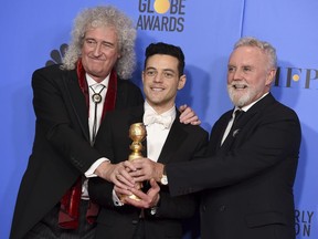 Brian May, left, and Roger Taylor, right, of Queen, and Rami Malek pose in the press room with the award for best motion picture, drama for "Bohemian Rhapsody" at the 76th annual Golden Globe Awards at the Beverly Hilton Hotel on Sunday, Jan. 6, 2019, in Beverly Hills, Calif.