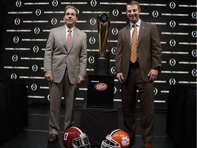Alabama head coach Nick Saban and Clemson head coach Dabo Swinney pose with the trophy at a news conference for the NCAA college football playoff championship game Sunday, Jan. 6, 2019, in Santa Clara, Calif.