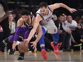 Los Angeles Lakers guard Josh Hart, left, and Detroit Pistons guard Jose Calderon go after a loose ball during the first half of an NBA basketball game Wednesday, Jan. 9, 2019, in Los Angeles.