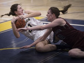 Windsor Lancers forward Samantha Gucciardi battles for a lose ball with McMaster Marauders' Christina Buttenham in OUA women's basketball action on Wednesday at the St. Denis Centre.