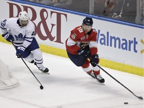 Florida Panthers defenseman Mike Matheson controls the puck next to Toronto Maple Leafs center Nazem Kadri during the third period of an NHL hockey game, Jan. 18, 2019, in Sunrise, Fla.