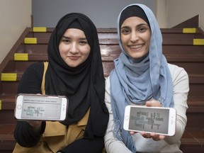Somewhere to turn to for help. Vincent Massey Grade 12 student Iman Berry, 17, the public school board's city student trustee, and Layla Bakaa, 17, a Grade 12 student at Leamington District High School, hold up their smartphones displaying a new website that helps students and parents deal with mental health issues.