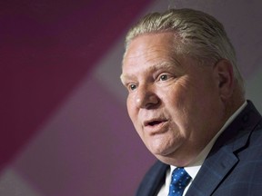 Ontario Premier Doug Ford speaks to the media during a press conference in downtown Toronto on Dec. 18, 2018. A spokeswoman for Ontario's premier says Ford will use a trip to a Detroit auto show to meet with executives from General Motors and several other automakers today.