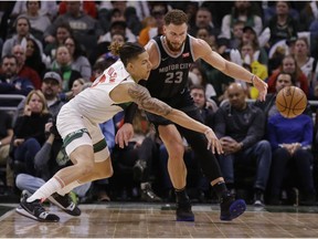 Milwaukee Bucks' D.J. Wilson, left, knocks the ball away from the Detroit Pistons' Blake Griffin during the second half of an NBA basketball game Tuesday, Jan. 1, 2019, in Milwaukee.