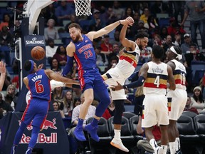 Detroit Pistons forward Blake Griffin passes the ball to centre Zaza Pachulia as New Orleans Pelicans center Jahlil Okafor defends during the second half of an NBA basketball game in New Orleans on Jan. 23, 2019. The Pistons won 98-94.