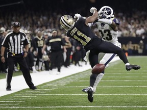 New Orleans Saints wide receiver Tommylee Lewis works for a coach against Los Angeles Rams defensive back Nickell Robey-Coleman during the second half the NFL football NFC championship game Sunday, Jan. 20, 2019, in New Orleans. The Rams won 26-23.