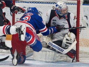 Kitchener Rangers Jonathan Yantsis collides with Windsor Spitfires goalie Kari Piiroinen during first period OHL action on Friday.