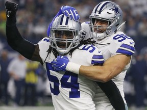 Dallas Cowboys players' Jaylon Smith (54) and Windsor's Tyrone Crawford (98) celebrate a play against the Seattle Seahawks first half of the NFC wild-card NFL football game in Arlington, Texas, Saturday, Jan. 5, 2019.