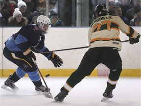 The Amherstburg Admrials' Reid Stieler, left, battles for a loose puck with Wallaceburg's Jake Vancoillie during a game in the Outdoor Shinny Series on Saturday at Lanspeary Park.