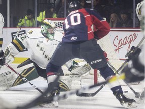 Windsor Spitfires centre Jordan Frasca tries to get his stick on the puck in front of London Knights' goalie Joseph Raaymakers during Thursday's game at the WFCU Cemtre.