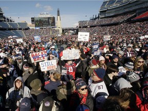 New England Patriots fans hold placards and cheer during an NFL football Super Bowl send-off rally for the team, Sunday, Jan. 27, 2019, in Foxborough, Mass. The Los Angeles Rams are to play the Patriots in Super Bowl on Feb. 3, in Atlanta, Ga.