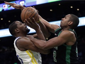 Golden State Warriors forward Kevin Durant, left, is fouled by Boston Celtics center Al Horford as he goes up to shoot in the second half of an NBA basketball game, Saturday, Jan. 26, 2019, in Boston.