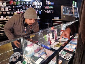 A salesperson at a cannabis shop in Seattle helps a customer select products in this January 2018 file photo.