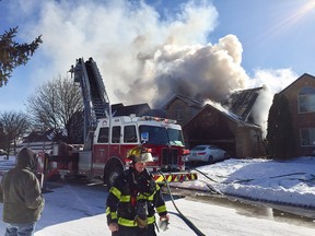 Windsor firefighters battle a blaze at 9765 Menard St. in Windsor's Riverside area on Jan. 21, 2019.