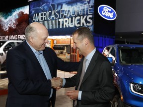 Ford Motor Co. President and CEO, Jim Hackett, left, meets with Dr. Herbert Diess, CEO of Volkswagen AG, Monday, Jan. 14, 2019, at the North American International Auto Show in Detroit.