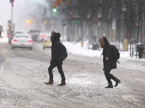 Pedestrians in winter coats make their way across Ouellette Avenue on Jan. 19, 2019.