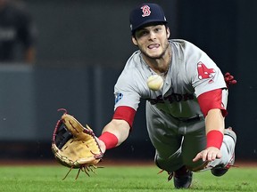 In this Oct. 17, 2018, file photo, Boston Red Sox' Andrew Benintendi makes a diving catch against the Houston Astros in Game 4 of the American League Championship Series in Houston. (Christopher Evans/The Boston Herald via AP, File)