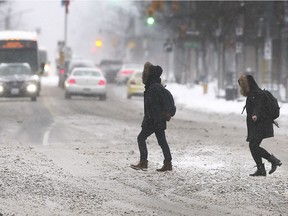 Pedestrian cross Ouellette Ave. in Windsor, ON. on Saturday, January 19, 2019, during a heavy snowfall.