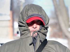 Windsor resident Matthew Kimmerly protects himself from the cold on his morning walk in the Riverside area on Jan. 21, 2019.