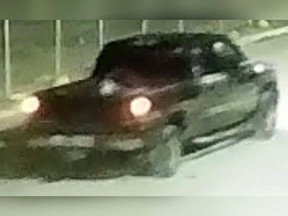 A surveillance camera image of a black pickup truck that LaSalle police say was involved in the theft of hundreds of metres industrial wire.