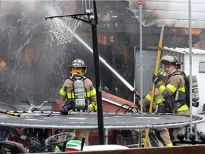 Windsor firefighters battle a house fire at 1690 Leduc Street Tuesday.  The blaze caused extensive damage to the single family home.  North and southbound traffic on Campbell Avenue was rerouted for several hours.