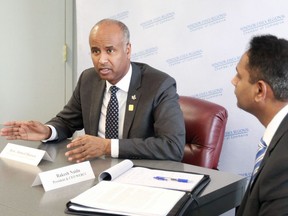 Minister of Families, Children and Social Development Ahmed Hussen is seen in a 2019 file photo speaking with Windsor Regional Chamber of Commerce president Rakesh Naidu, right.