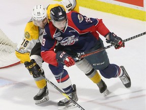 Windsor, Ontario. February 14, 2019 - Windsor Spitfires Curtis Douglas in tight quarters with Sarnia Sting Theo Hill in OHL first period action from WFCU Centre.