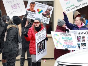 Jillian Fenech, centre, joined about 100 other parents of autistic children protesting the province's plans for program funding.  The rally took place on Erie Street East at the office of Ministry of Children and Youth Services.