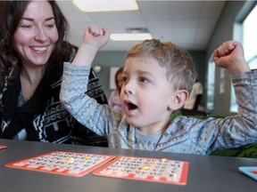 Nicolas Palmer, 4, celebrates during a game of bingo with his mother Andrea Palmer at Tecumseh Recreation Complex Family Day activities Monday.  Nicolas and his sister Gabriella, 6, (not shown) had front row seats for the family entertainment.